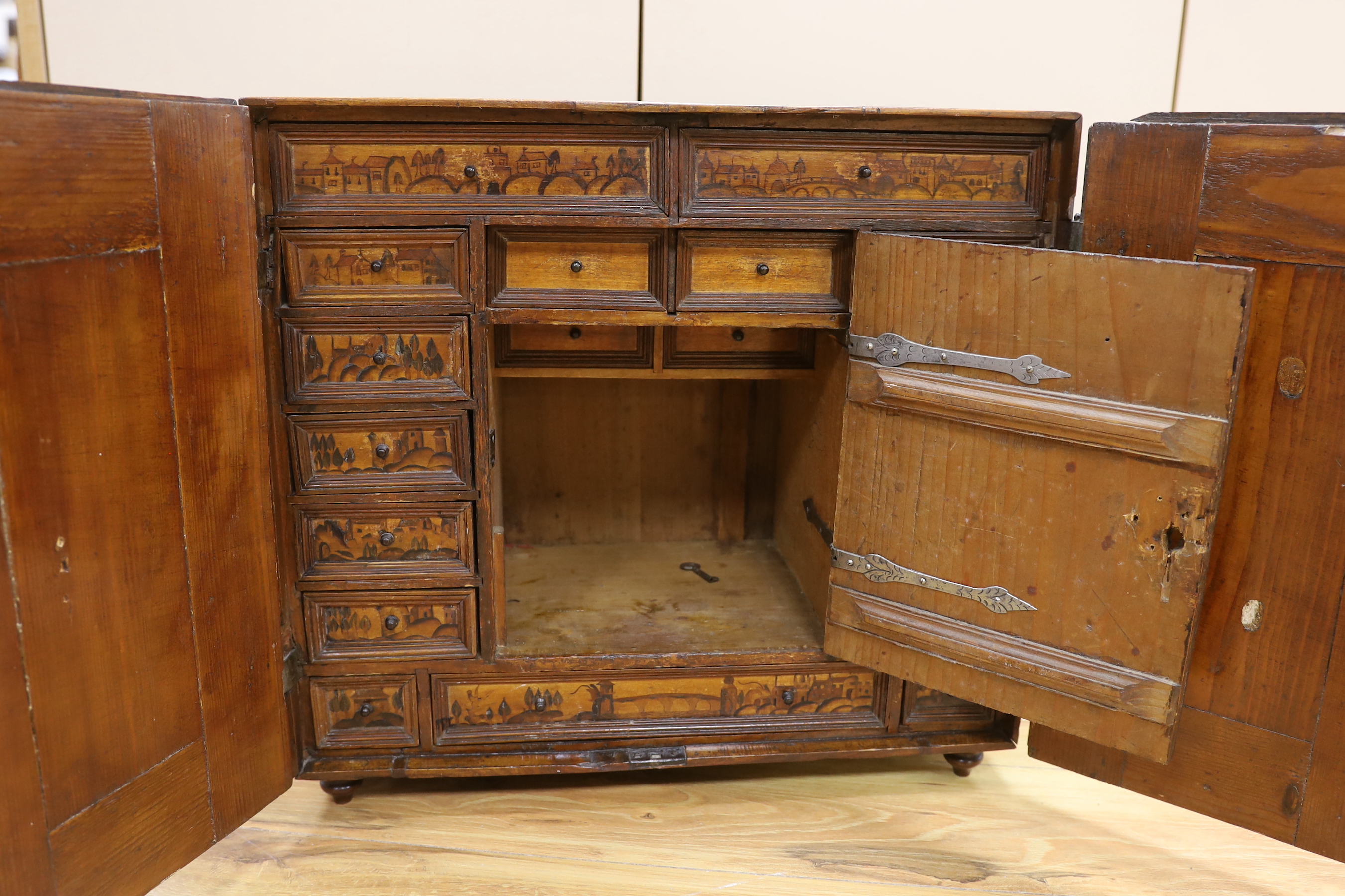 An early 18th century South German marquetry and penwork table top collector's cabinet, 49cm high, 52.5cm wide, 27cm deep